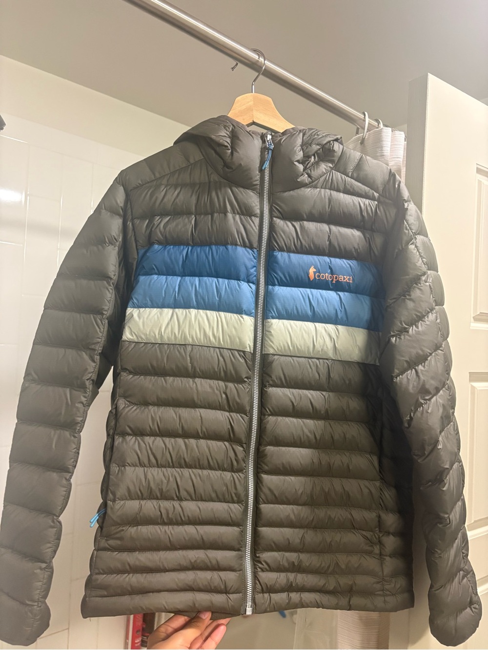 Cotopaxi Men’s Olive Puffer Jacket with blue and green stripes